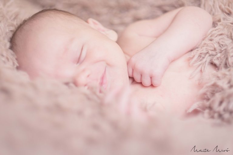 Fotografía de newborn durmiendo y sonriendo